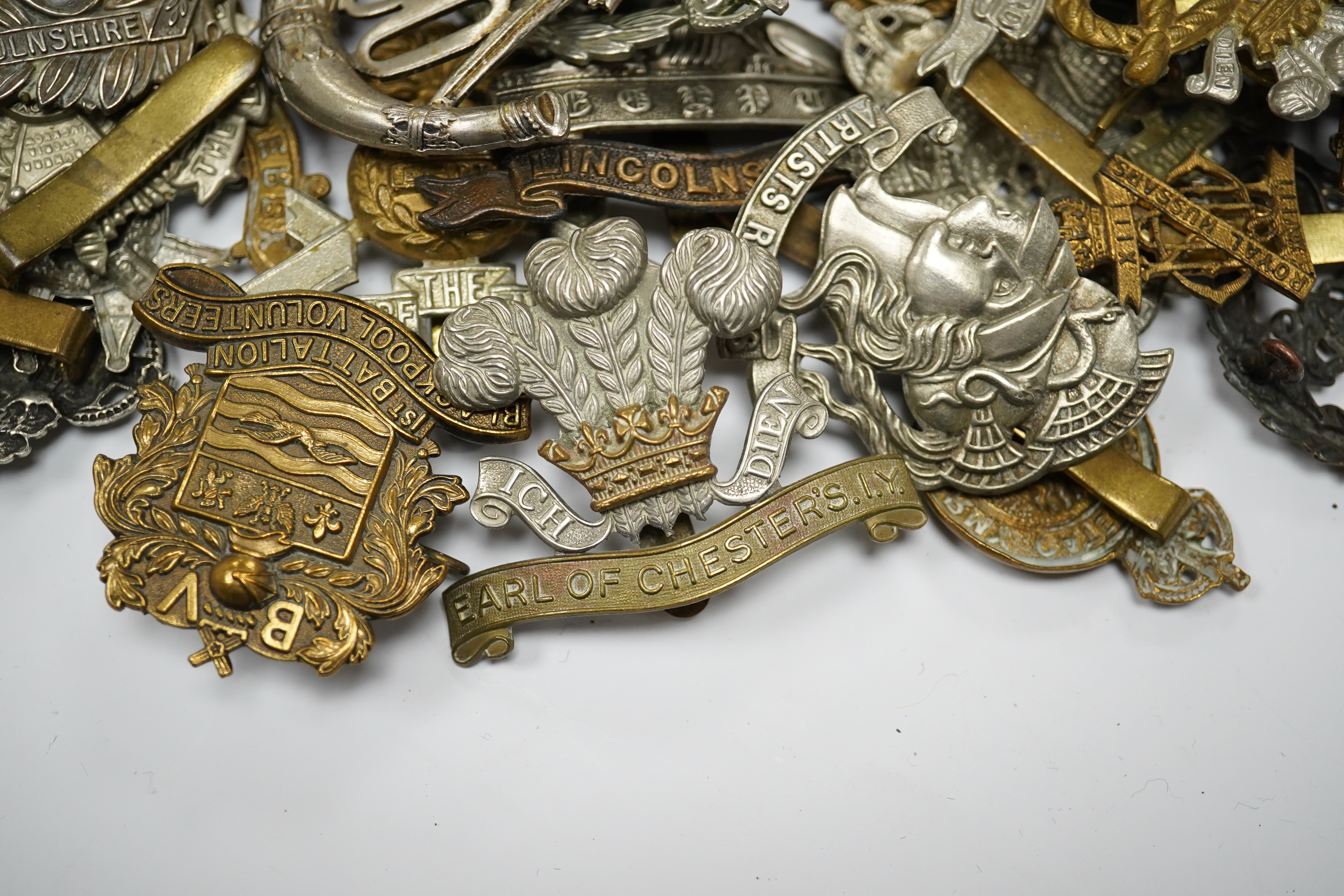 Sixty military cap badges including; the Lancashire Hussars, the Royal Corps of Signals, the Essex Regiment, the Royal Engineers, the North Stafford Regiment, the Border Regiment, the Glamorgan Yeomanry, etc. Condition f